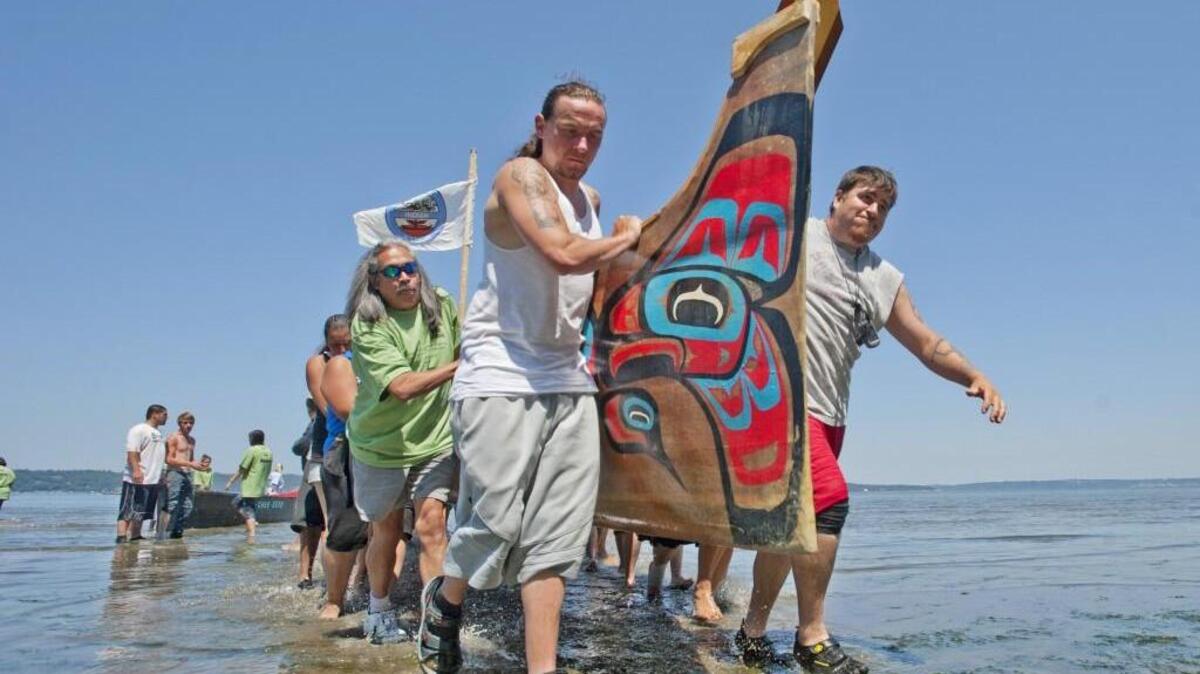 A Quinalt canoe is carried ashore at Dash Point State Park as the Puyallup Tribe welcomes each of about 100 canoes participating in Paddle to Squaxin 2012.  
July 25, 2012
Peter Haley / Staff photographer