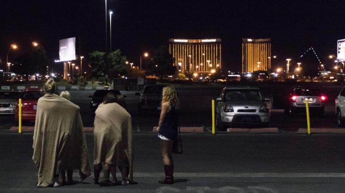 A group of women wait for their ride outside the Thomas & Mack center, which served as a refuge following a mass shooting at the Route 91 music festival along the Las Vegas Strip.