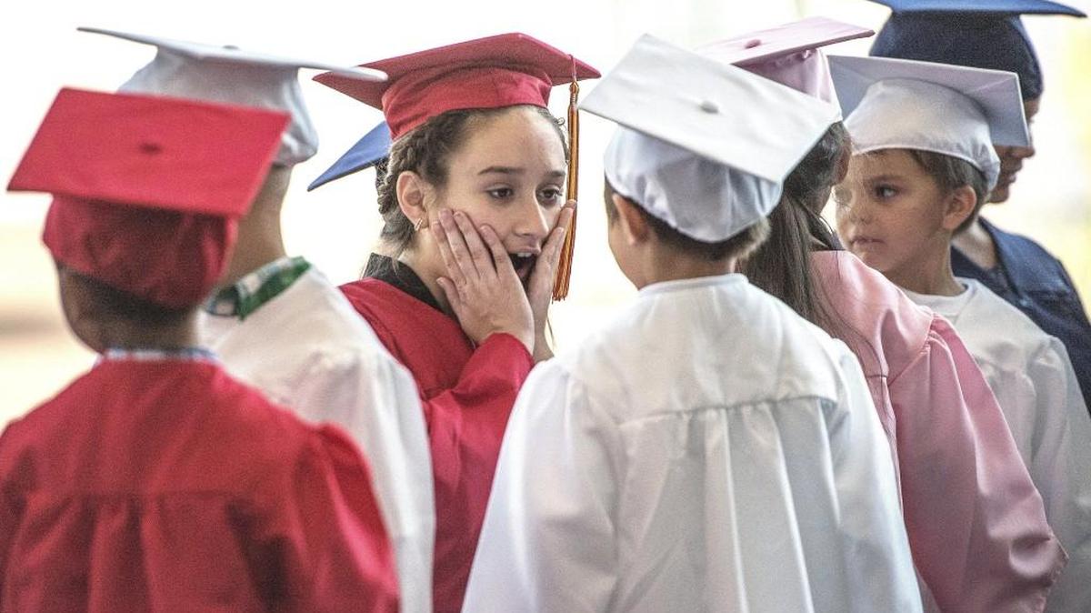 Mount Tahoma High School student Kadire Haliti, Class of 2020, reacts with surprise after being asked to look into the eyes of her partner from Whitman Elementary School to see what color they are. They participated in a Graduate Tacoma event that introduces high school students of the present to those of the future.