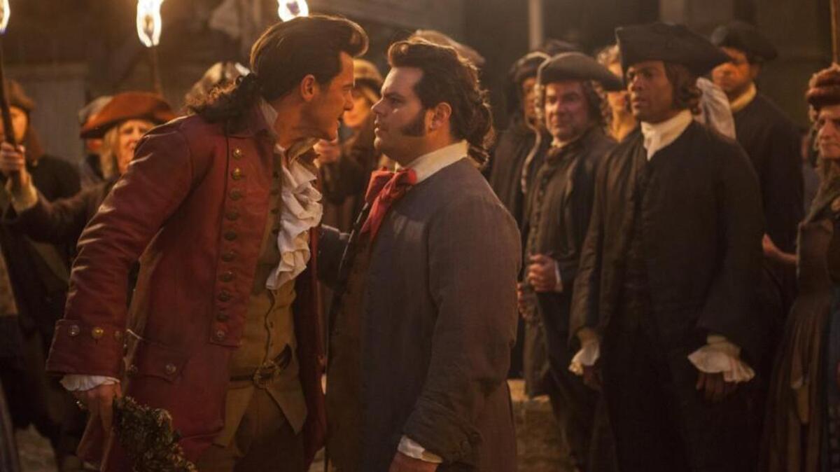 Luke Evans as Gaston, left, with Josh Gad as LeFou, in “Beauty and the Beast.”