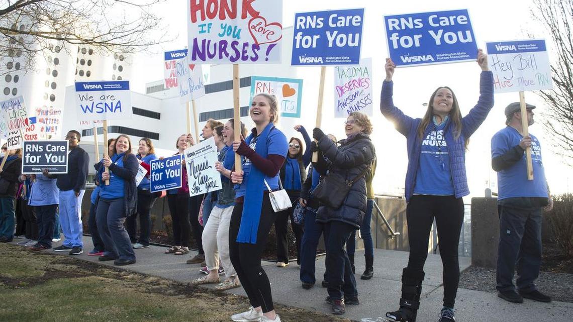 Annalise Rutt (center), a registered nurse from Tacoma, joins fellow nurses as they rally for a new contract during a March 21 informational picket outside St. Joseph Medical Center in Tacoma.