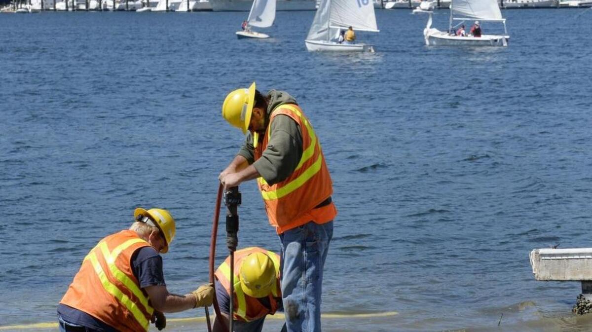 A Pierce County road operations crew secures articulated concrete blocks, part of the new boat launch installed at the end of Randall Drive Northwest in Gig Harbor in 2014. Charter Amendment 45 on the general election ballot would free up county crews to do more projects.