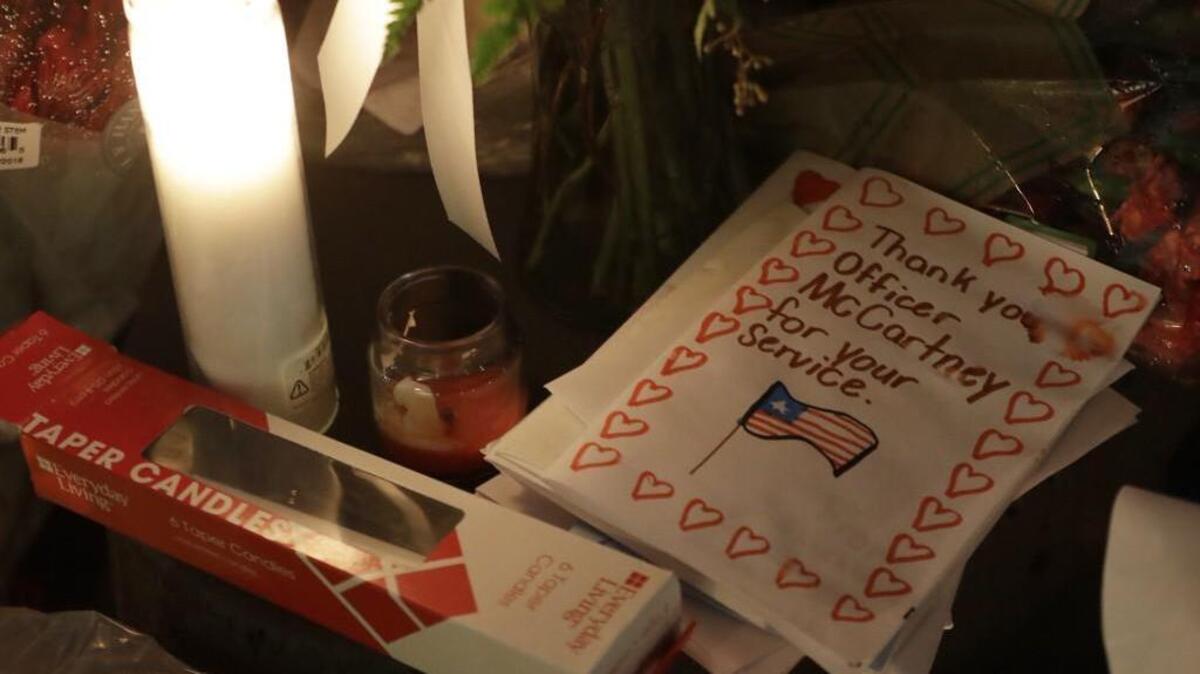 A child’s card for fallen Pierce County Sheriff’s Deputy Daniel McCartney is part of a growing memorial to him at the South Precinct headquarters.