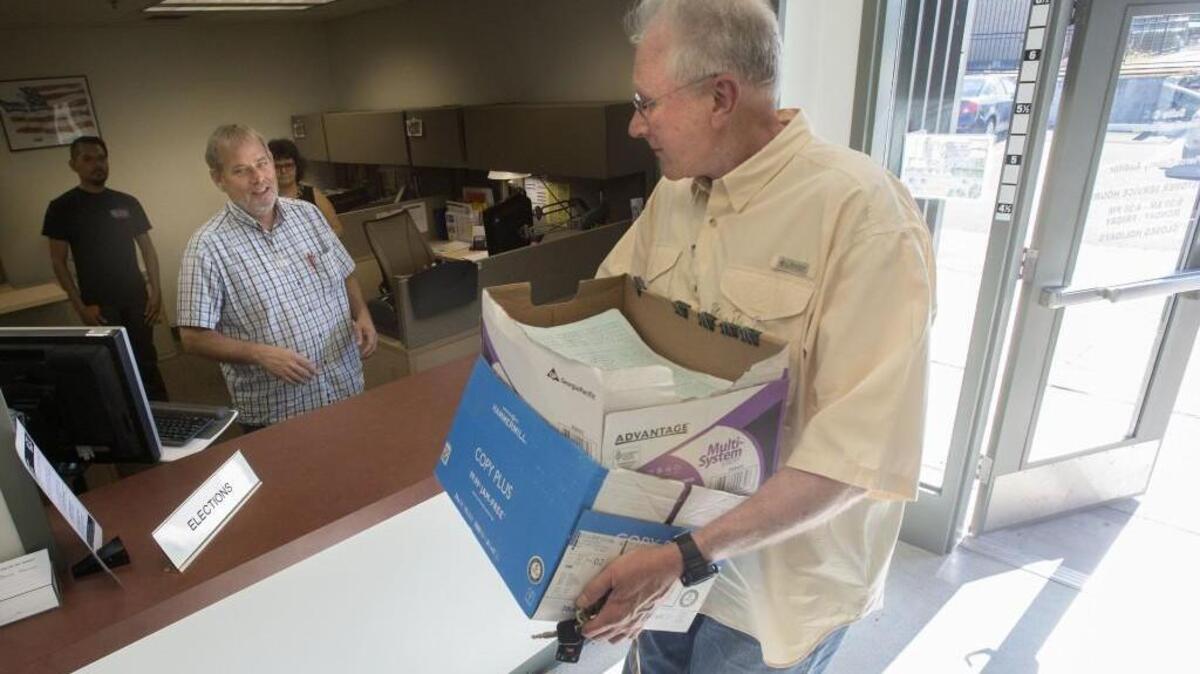 Jerry Gibbs of Gig Harbor turns in boxes of petition signatures for a citizen referendum challenging Pierce County’s proposed general services building in 2015. The referendum made it to the ballot, and the building was killed.