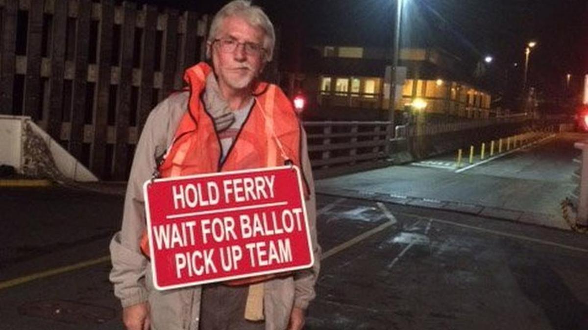 David Droge performs an election worker duty: persuading the Anderson Island ferry crew to wait for ballots to be picked up.