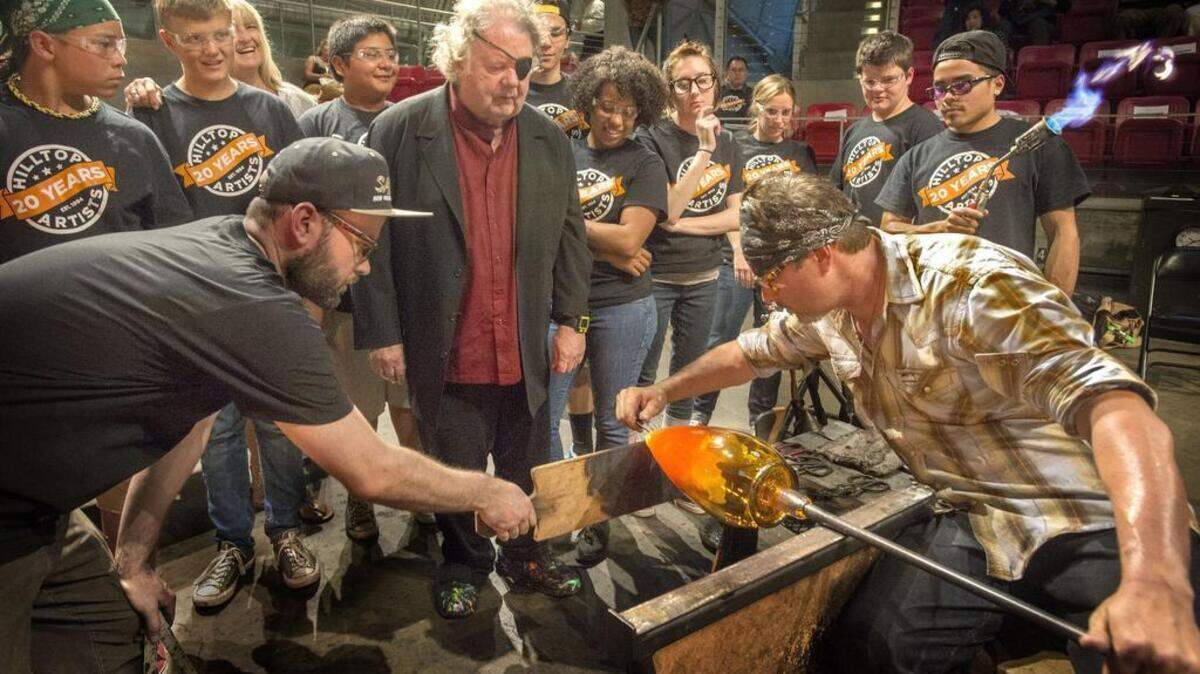 Glass artist Dale Chihuly, center, co-founder of .Hilltop Artists, is asking Tacoma voters to say “yes” to Proposition One.