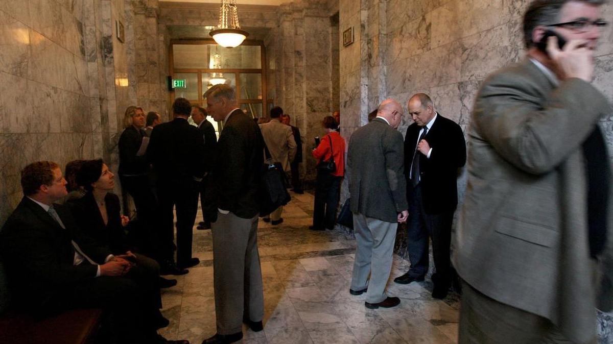 The hallways next to both the Senate and House Chambers in Olympia are a buzz of activity as legislators, lobbyists and interested parties converge. Proposed legislation would require a one-year wait before statewide elected officials, state legislators, agency heads and senior staff could be paid to lobby their former employer.