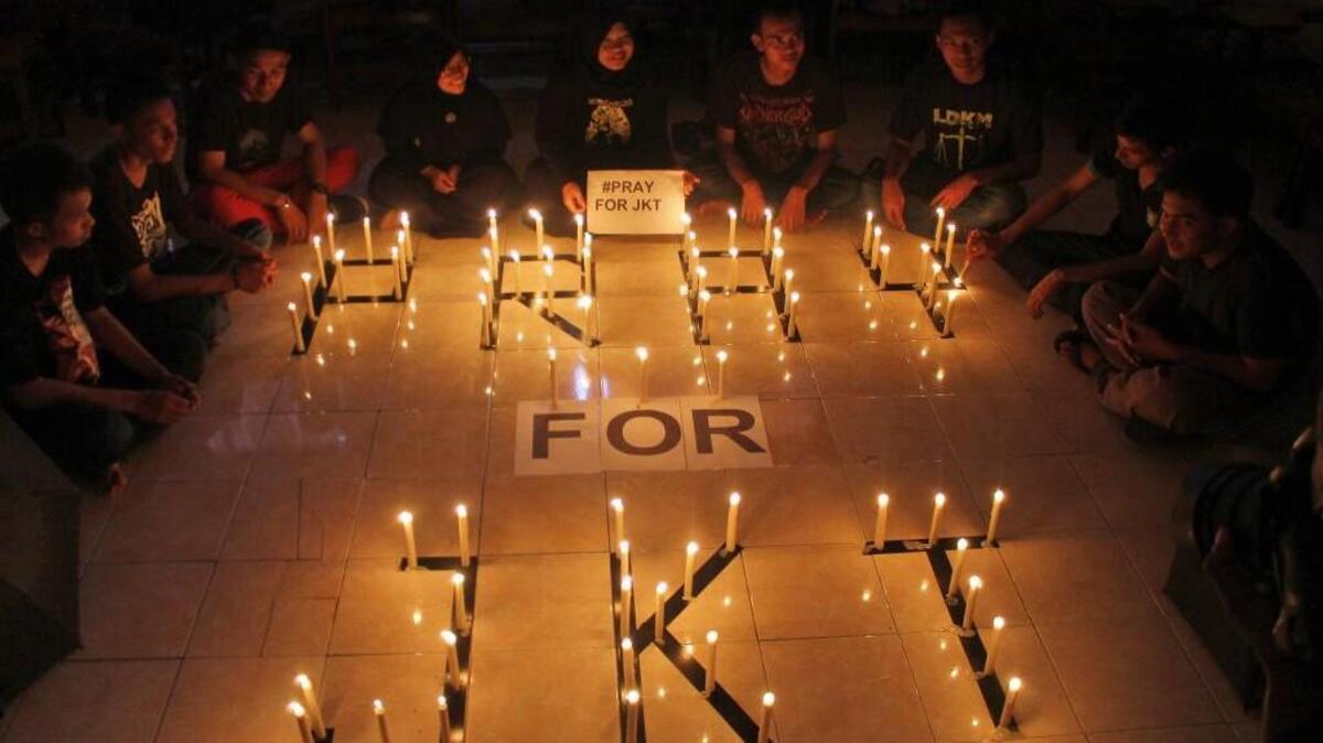 Students light candles during a vigil in Surabaya, East Java, Indonesia, on Thursday. Indonesians were shaken but refusing to be cowed a day after the deadly attack claimed by the Islamic State group in a busy district of central Jakarta.
