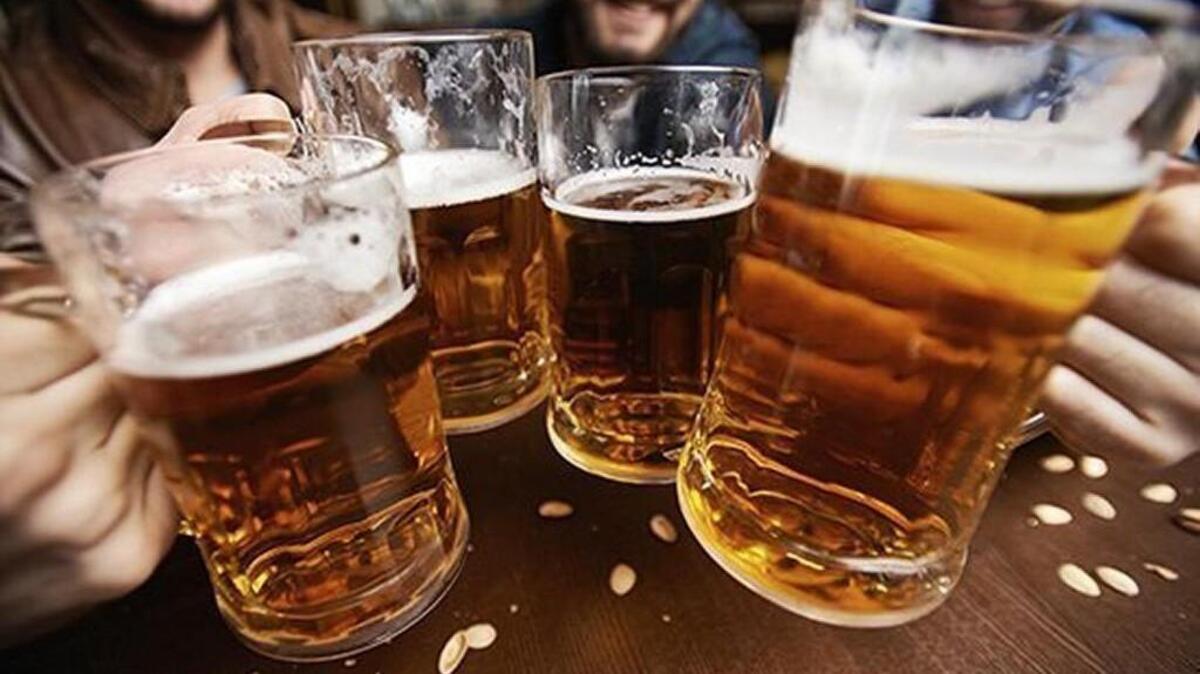 Four men toasting with fresh beer