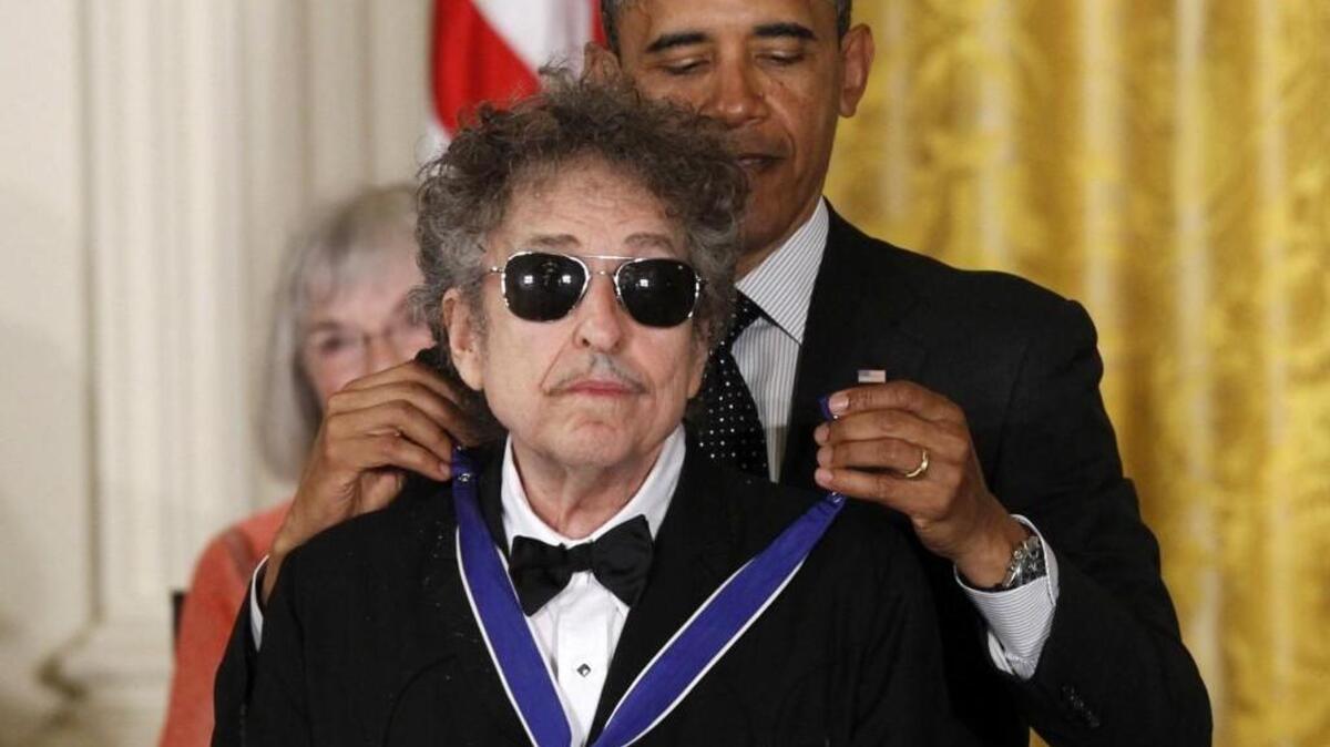 President Barack Obama presents rock legend Bob Dylan with a Medal of Freedom during a ceremony at the White House in 2012. The award was a prelude to the 2016 Nobel Prize in literature, announced last week.