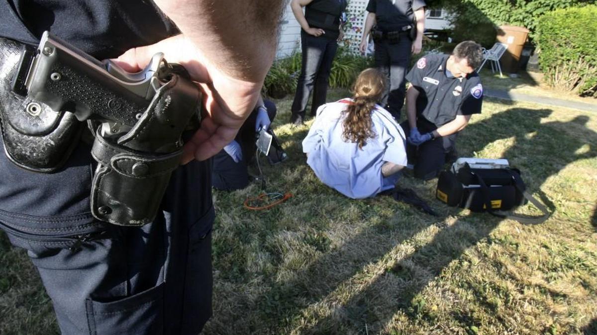 A Tacoma paramedic checks the vital signs of a suspect who was taken down with a stun gun after running from Tacoma Gang Unit officers. Specialty units like this are the first casualties of budget cuts, columnist Brian O’Neill says.