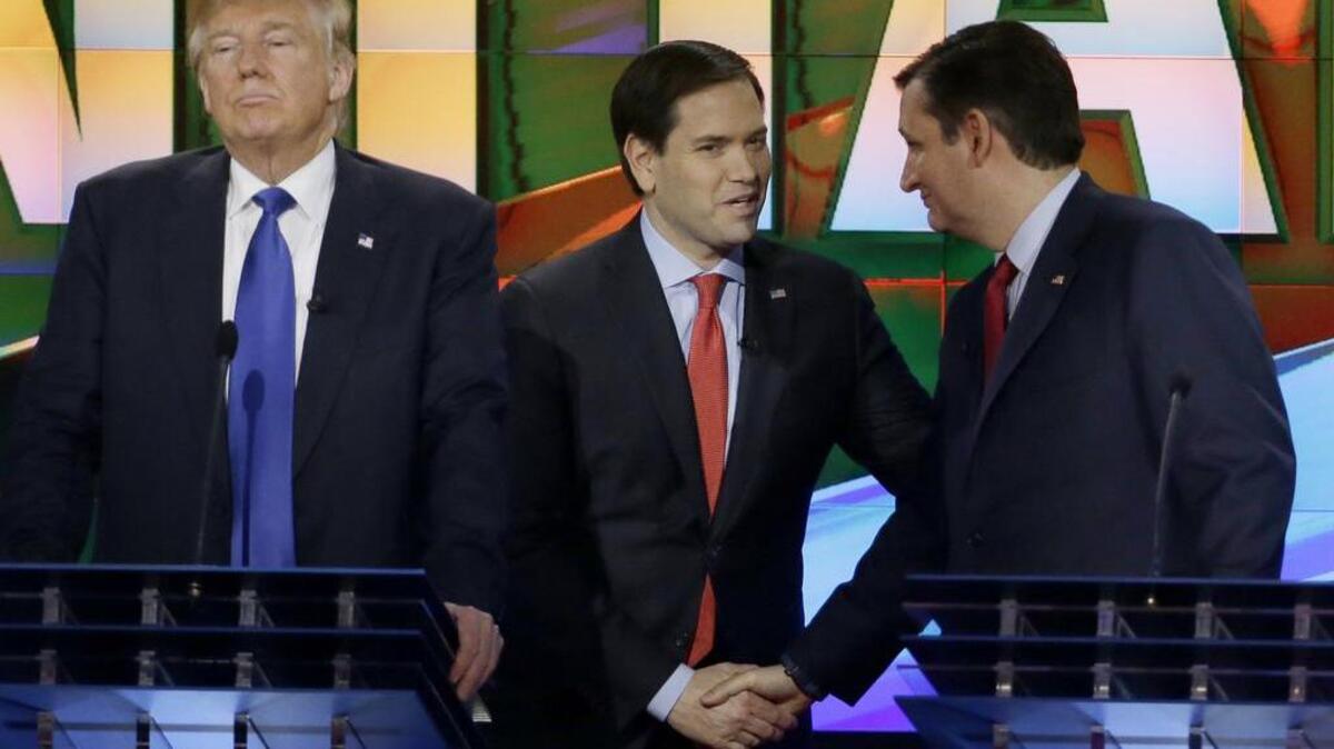 Republican presidential candidate Donald Trump, left, pauses as Sen. Marco Rubio, R-Florida, center and Sen. Ted Cruz, R-Texas, greet at a break during a presidential primary debate at the University of Houston Feb. 25.