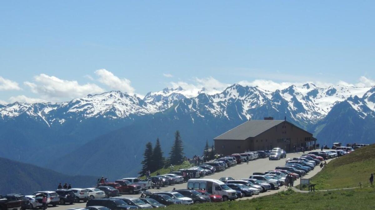 Hurricane Ridge Visitor Center in Olympic National Park often sees big crowds and full parking lots. A large proposed gate fee increase at several national parks, including Olympic and Mount Rainier, will help thin crowds and address deferred maintenance. But that doesn’t make it a good idea.