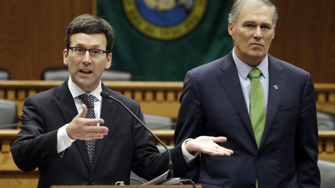 Washington Attorney General Bob Ferguson, left, talks to reporters as Washington Gov. Jay Inslee looks on during the Associated Press' annual Legislative Preview event in early January.