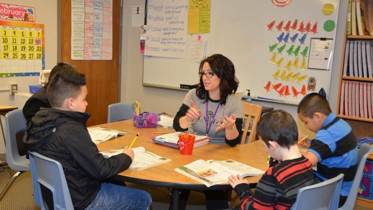 Puyallup paraeducator Carie Sauders works with students at Firgrove Elementary School in Puyallup. The Puyallup School District is one of a dozen school districts with renewal levies on the Feb. 13 ballot.