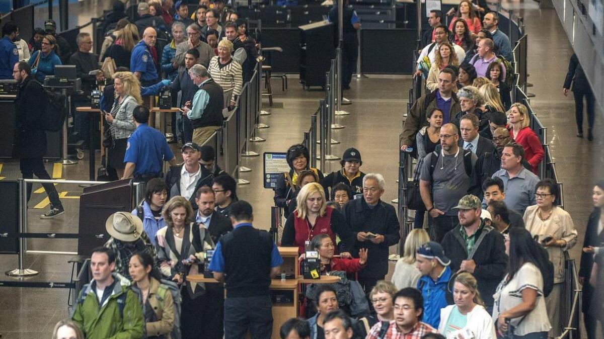 Some security experts believe air passengers and their luggage should be screened before they ever get to the airport to avoid the kind of attack in Brussels, Belgium. Here passengers queue up at the security checkpoint at Sea-Tac International Airport.