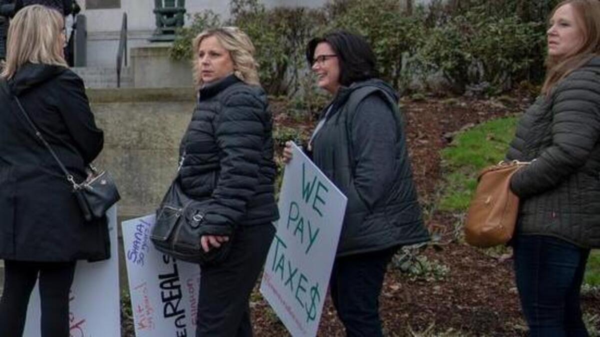 Get out of our hair, members of the state Beauty Profession Alliance told lawmakers this week at a public hearing on Senate Bill 5326, which would tighten rules on beauty shop booth rentals. These women wait outside the Capitol in Olympia before the hearing.
