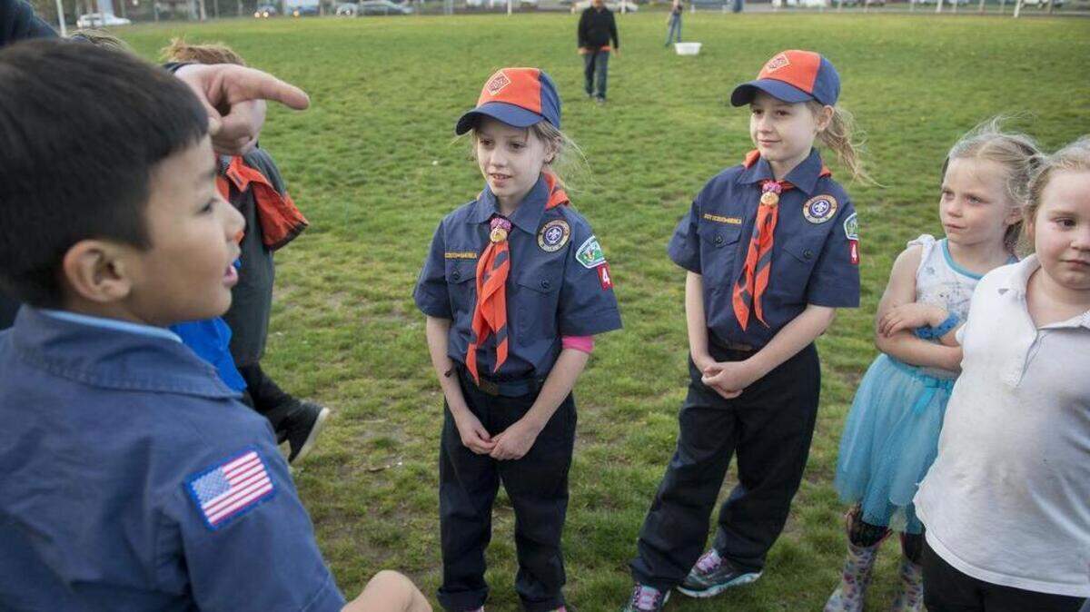 Lily Frazier (left) and sister Anna Frazier gather with other Cub Scouts during their Boys Scouts of America pack meeting at Fern Hill Elementary School in Tacoma on Tuesday, April 10, 2018. The 7-year-old twins are the first South Sound girls to join the Boys Scouts of America since the group decided to add the option.