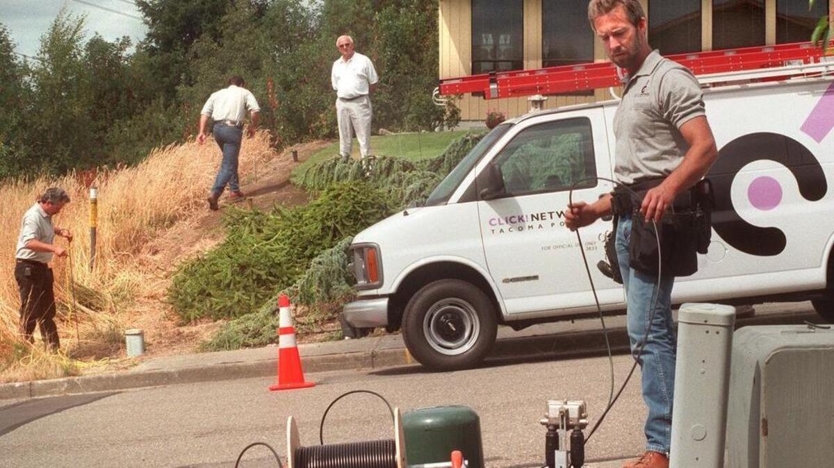 Click Cable TV technician Mark Wall feeds coaxial cable under a neighborhood street and into a home. Tacoma’s plan to work with a private partner, rather than spend public money, to reinvent Click as a full-service broadband network is finally picking up momentum.