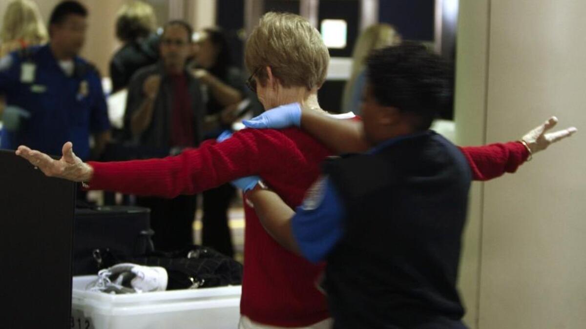 A TSA agent pats down a traveler at Los Angeles International Airport in 2011.