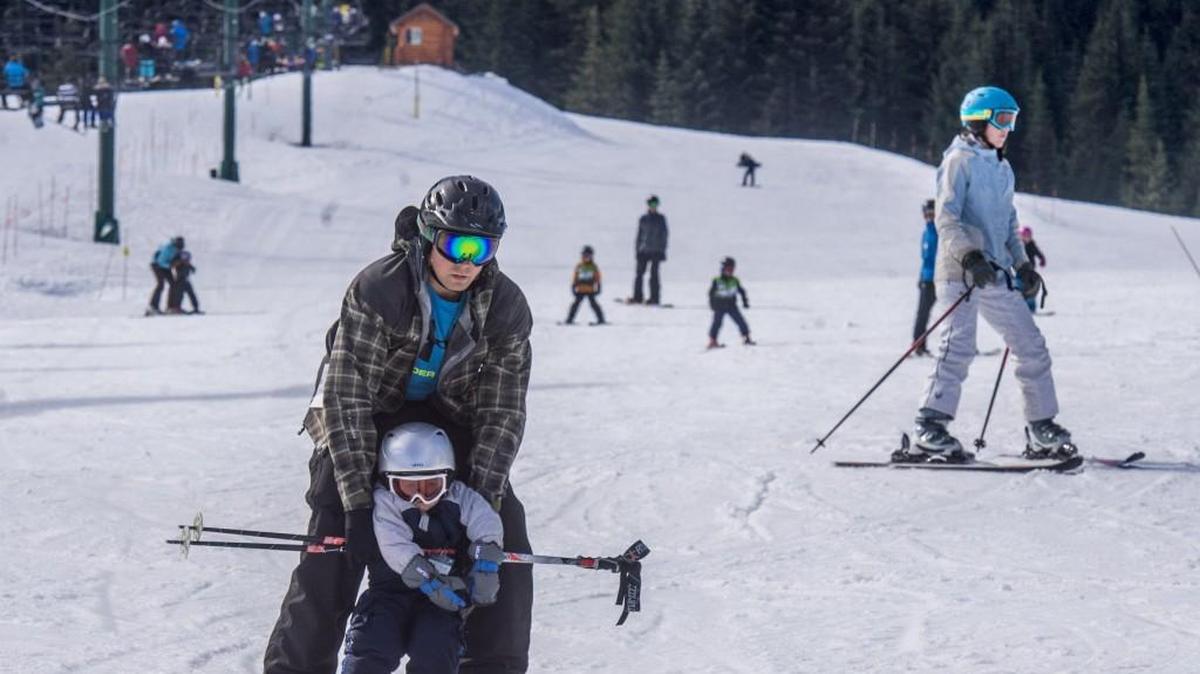 Beginning skiers swarm the bunny slope on a warm and sunny spring day at Crystal Mountain.
