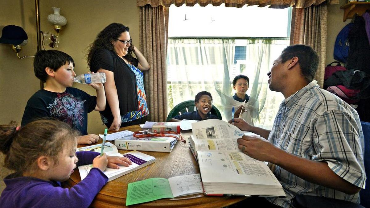 Studying together around the dining room table with their children, Shawna and Mike Allen were part of a Tacoma Housing Authority program that provides stable housing and other student support for dozens of families at McCarver Elementary School. The program is made possible through voter-approved school levy dollars.