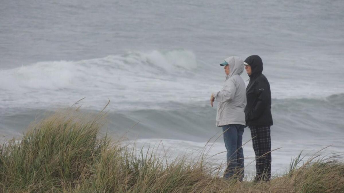 A bluff above the beach near Westport makes a good, but windy viewpoint to watch storm-driven waves crash ashore.