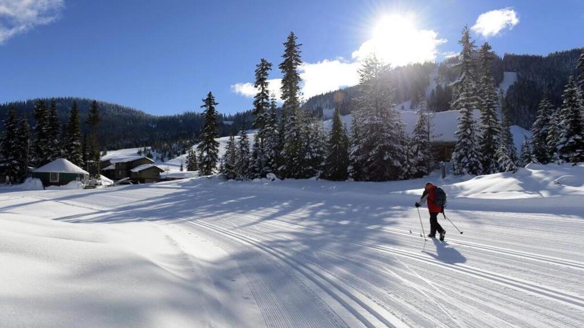 David Bjorkman of Yakima returns to the Nordic Center, background left, after cross-country skiing at White Pass, in 2013. The Nordic Center is adding a new yurt to keep up with demand this season.
