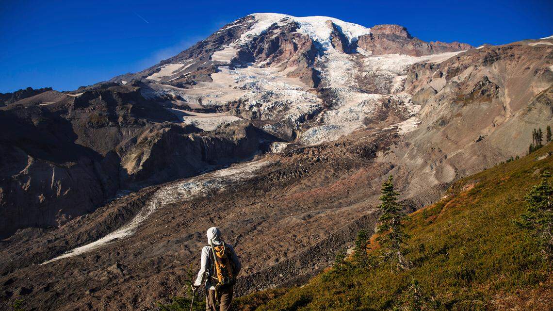 National Park Geomorphologist Paul Kennard climbs up to the receding Nisqually Glacier at Mount Rainier National Park in Washington state, Oct. 22, 2018. America’s glaciers are losing ice as the world warms. As they shrink and meltwater eventually declines, changes in water temperature, nutrient content and other characteristics will disrupt those natural communities. (Max Whittaker/The New York Times)