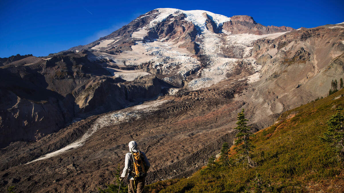 National Park Geomorphologist Paul Kennard climbs up to the receding Nisqually Glacier at Mount Rainier National Park in Washington state, Oct. 22, 2018. America’s glaciers are losing ice as the world warms. As they shrink and meltwater eventually declines, changes in water temperature, nutrient content and other characteristics will disrupt those natural communities. (Max Whittaker/The New York Times)