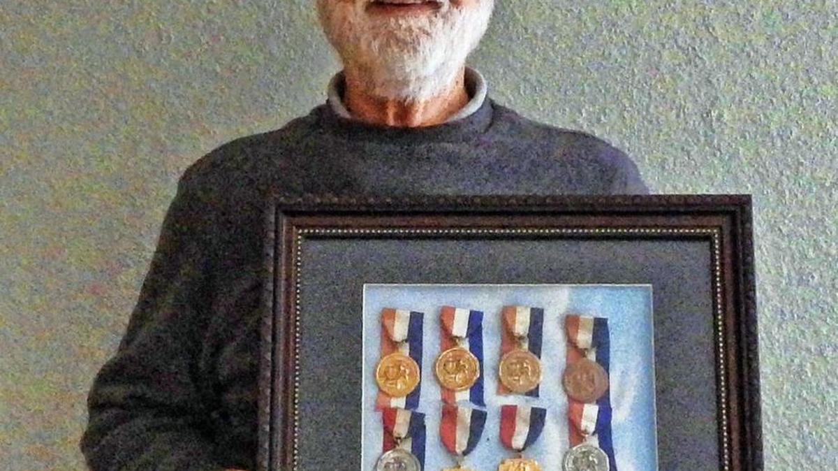 Tacoma’s Richard Perkins displays some of the medals he won racing bicycles in the 1940s and ’50s.