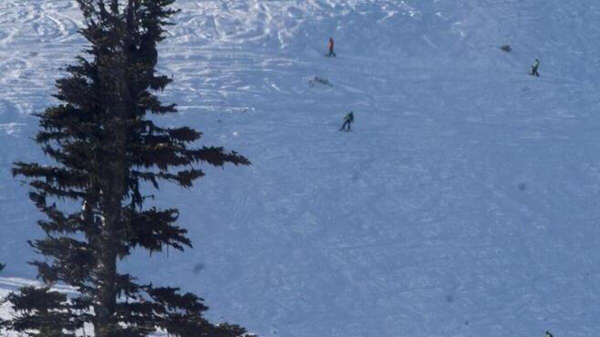 Skiers and boarders work their way down Green Valley below the mountaintop restaurant and gondola station at Crystal Mountain, December 1, 2014. Crystal Mountain may open Green Valley for the 2015-16 season on Nov. 19.