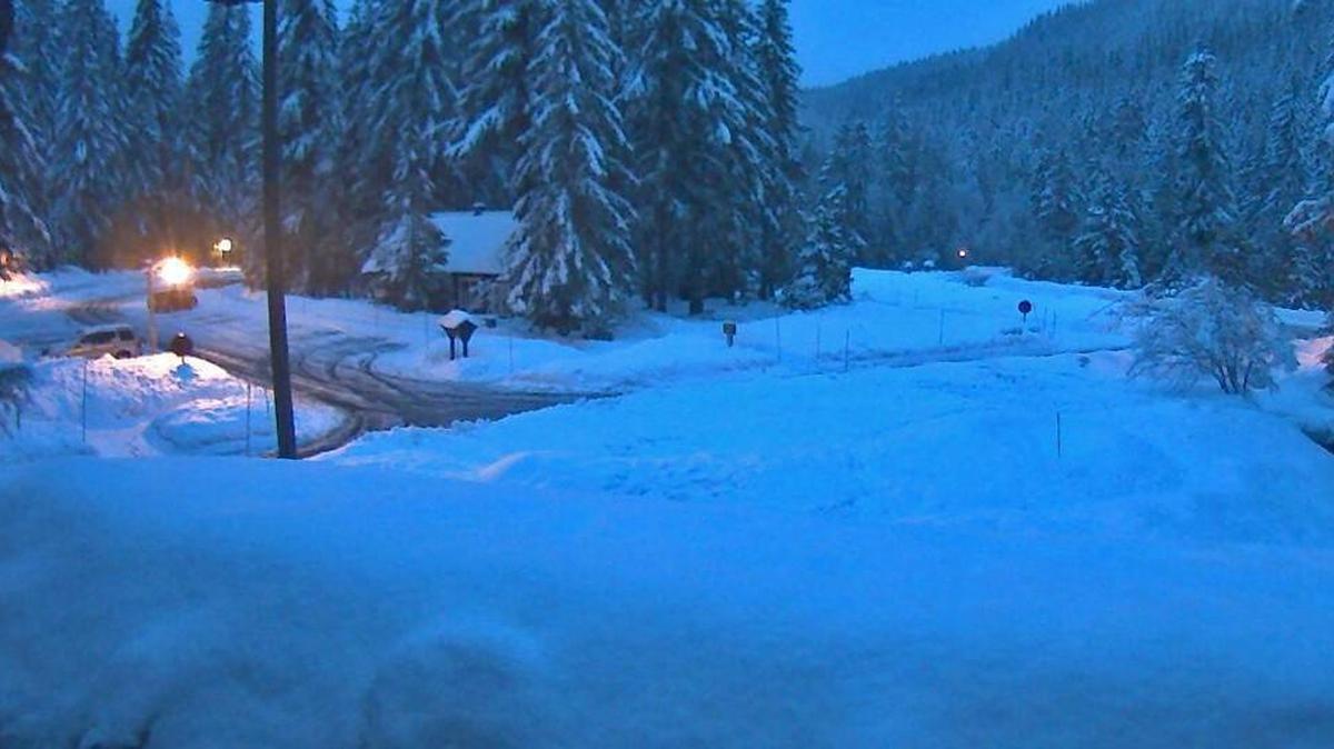 A snowplow clears the parking lot at the Longmire area of Mount Rainier National Park on Monday morning during a snowstorm. The park was closed for the day because of the snow and resulting power outages, the National Park Service announced on Twitter.