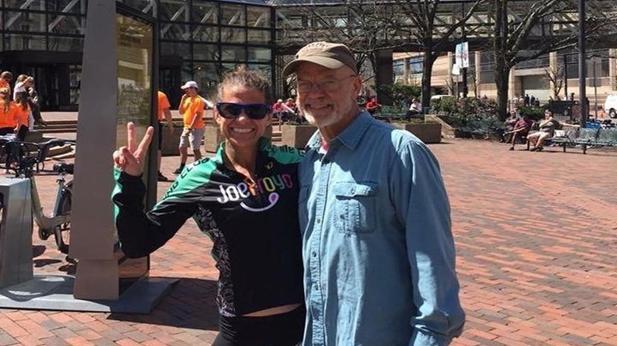 Kate Landau, 40, of Tacoma celebrates with her dad after her second-place finish in the Boston Marathon women’s masters division Monday.