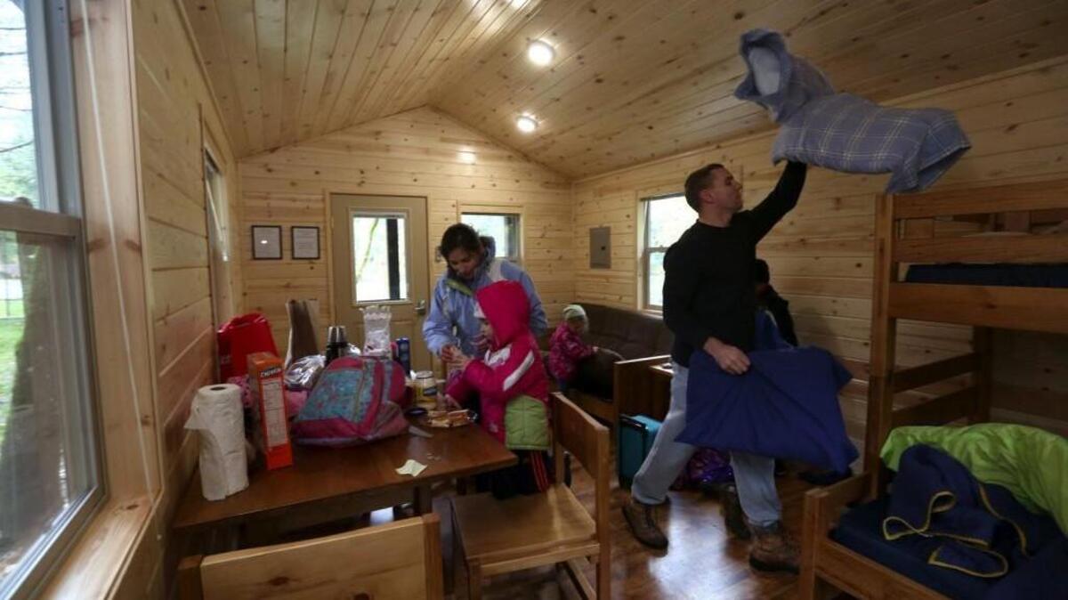 Julianne and David Thompson and their four children move into a cabin they rented at Dash Point State Park in Federal Way. The Thompsons, who live in Tacoma, are celebrating eight-year-old Simon’s birthday as well as just having a little family vacation.