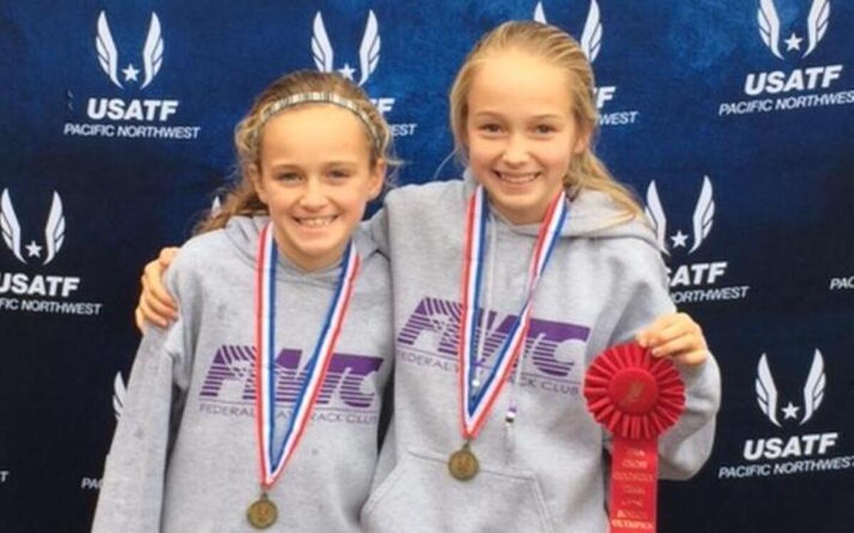 Ava (left) and Ella Borsheim of Tacoma and the Federal Way Track Club say they inspire each other.