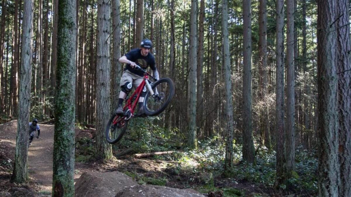 David French of SeaTac and Marcus Pitts, back, of Tacoma bike at high speeds down the more advanced trails of Swan Creek Park’s mountain bike trails in 2014. The second phase of the trail system is scheduled to open in 2016.