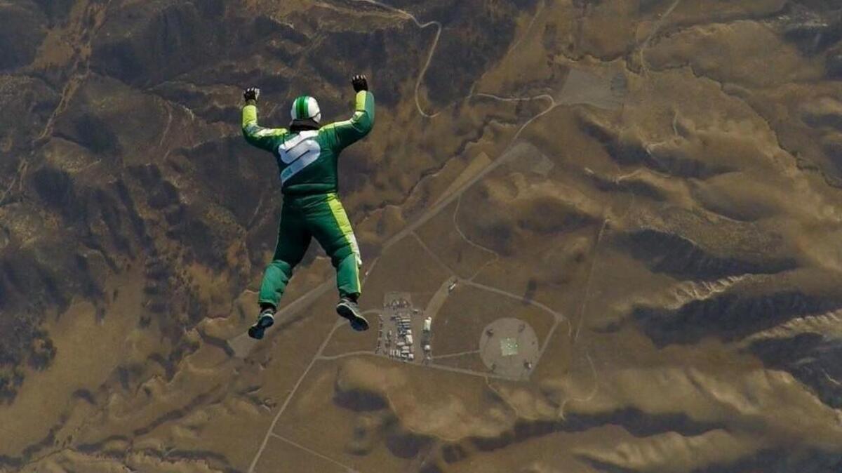 Luke Aikins of Shelton free falls toward a 100-by-100-foot net in Simi Valley, California. He jumped without a parachute from a plane at 25,000 feet on July 30.
