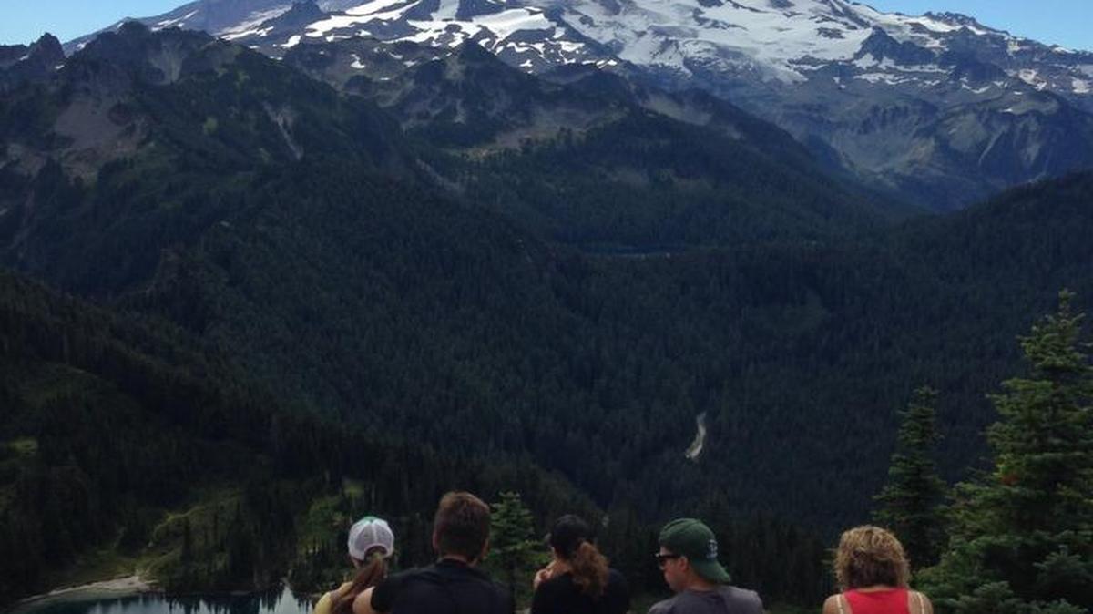 A group of hikers in front of the Tolmie Peak Lookout watch a lenticular cloud form atop Mount Rainier on Aug. 28.