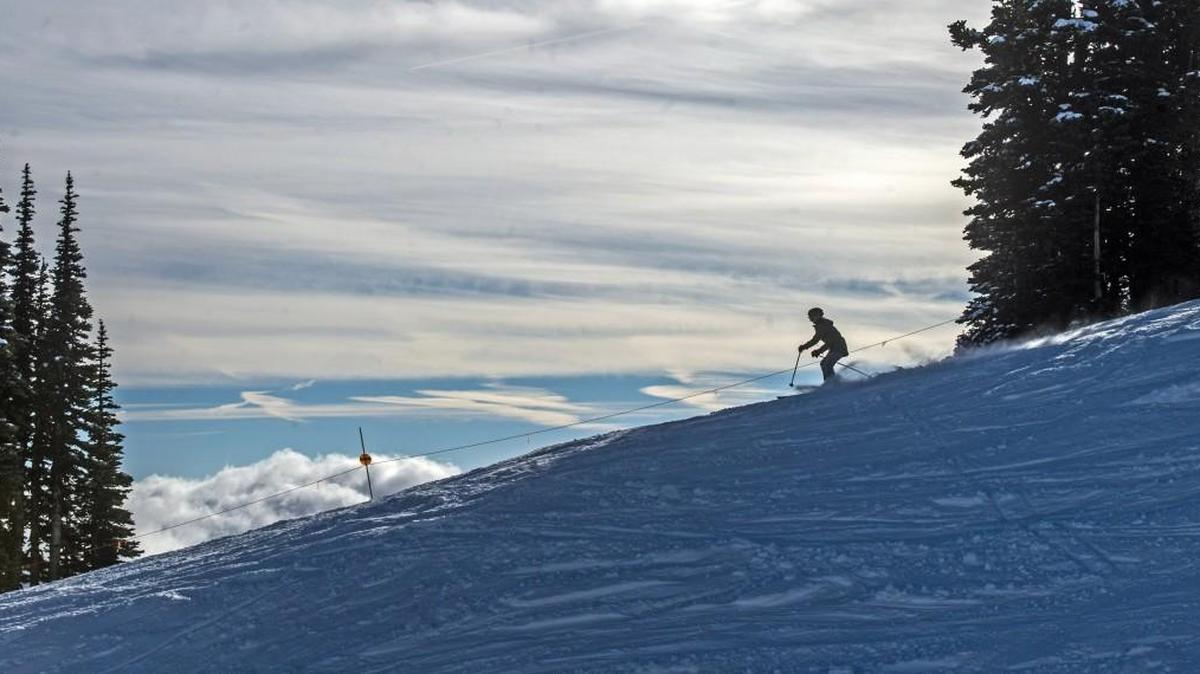 A skier cruises down Upper Ferk’s Run at Crystal Mountain, December 1, 2014. The ski area opened with minimal snow, allowing skiing on Green Valley Express only, with the gondola available for access to the mountaintop and views with great visibility.