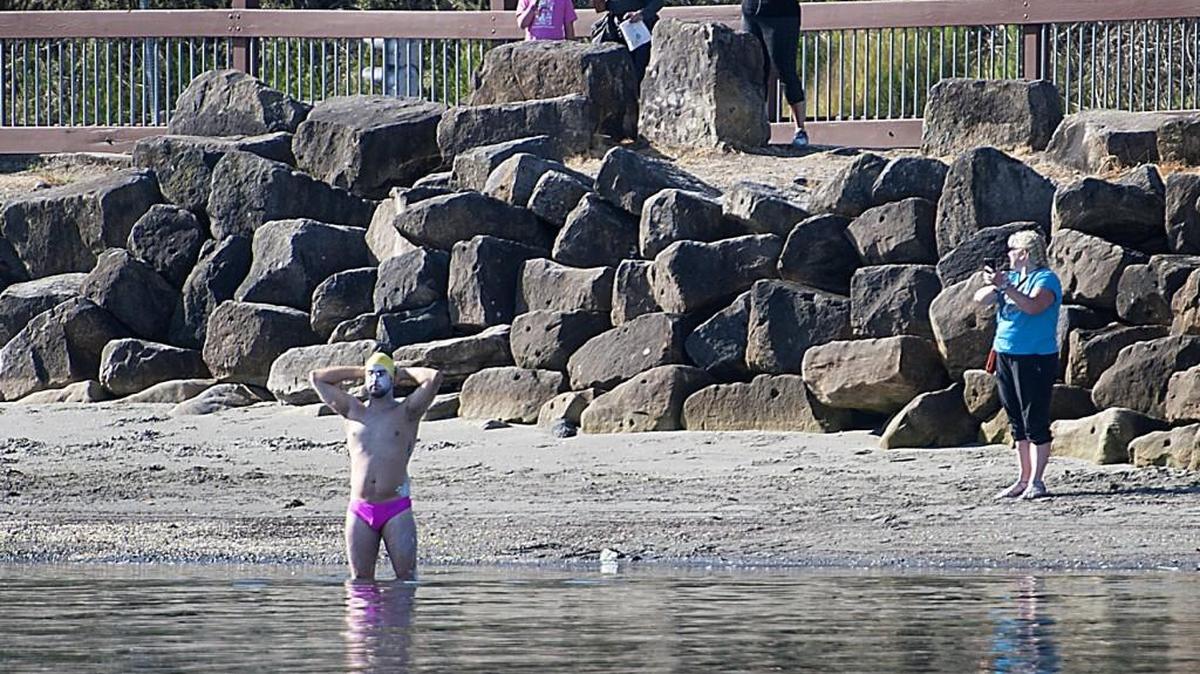
Seattle resident Andrew Malinak pauses for reflection at Jack Hyde Park in Tacoma on June 6, prior to attempting a historic 18.8-mile swim from Tacoma to West Seattle’s Lincoln Park, which he completed. The then-27-year-old dubbed his effort “The Return of Bert Thomas Swim” in honor of the notable long-distance swimmer from Tacoma who accomplished the feat on his third try in May 1956, the only know person to do so.
