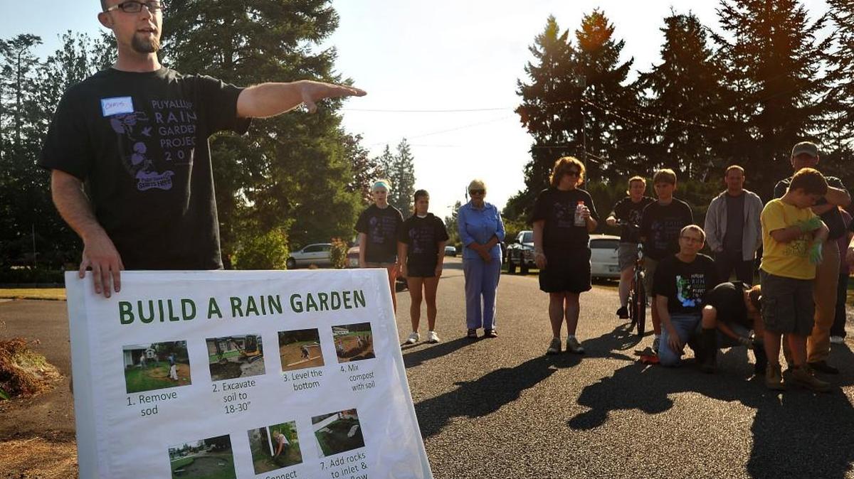 Chris Beale explains to volunteers how to install a rain garden in 2011. Beale is in his first year as president of ForeverGreen Trails.