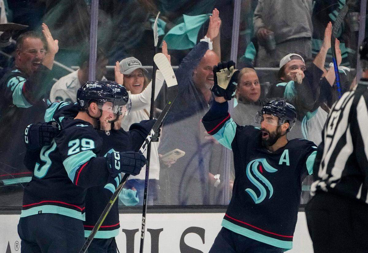 Seattle Kraken defenseman Vince Dunn (29) and right wing Jordan Eberle, right, celebrate a goal by left wing Tye Kartye, center, against the Dallas Stars during the second period of Game 6 of an NHL hockey Stanley Cup second-round playoff series Saturday, May 13, 2023, in Seattle. (AP Photo/Lindsey Wasson)