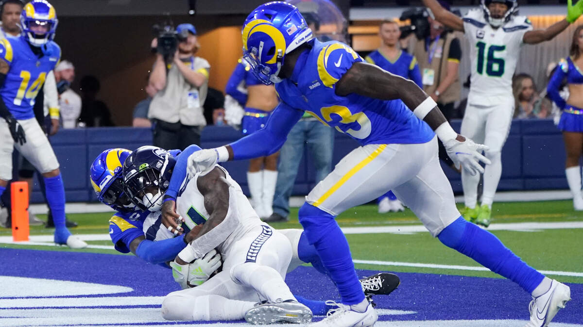 Seattle Seahawks wide receiver DK Metcalf catches a touchdown pass as Los Angeles Rams defensive back Jalen Ramsey, left, and safety Nick Scott (33) defend during the second half of an NFL football game Sunday, Dec. 4, 2022, in Inglewood, Calif. (AP Photo/Marcio Jose Sanchez)