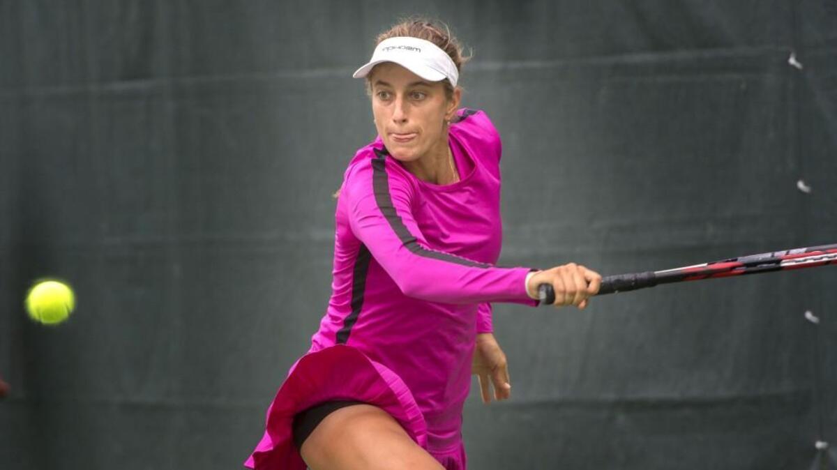 Jacqueline Cako tracks the ball on a return against Desirae Krawczyk during the women’s finals of the PNW tennis tournament at Tacoma Lawn Tennis Club on Sunday. Cako won 6-4, 6-2.