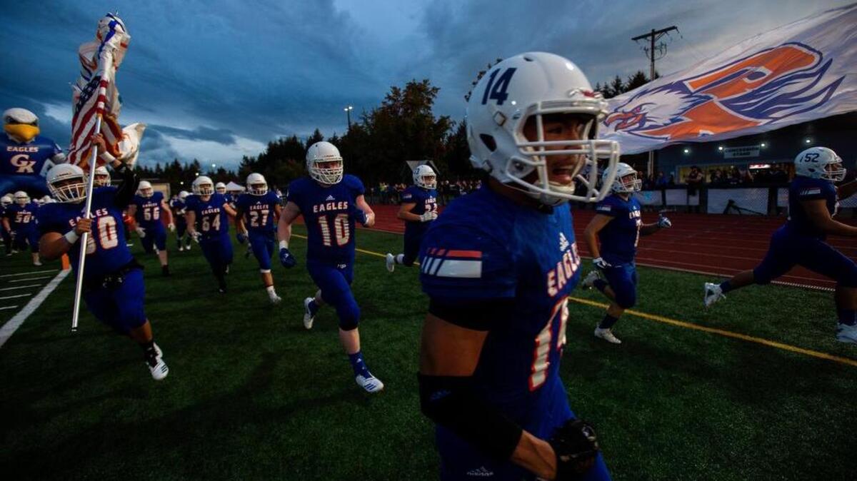 Graham-Kapowsin players take the field. Graham-Kapowsin played Puyallup in a football game at Art Crate Field in Spanaway, Wash., on Friday, Sept. 21, 2018.