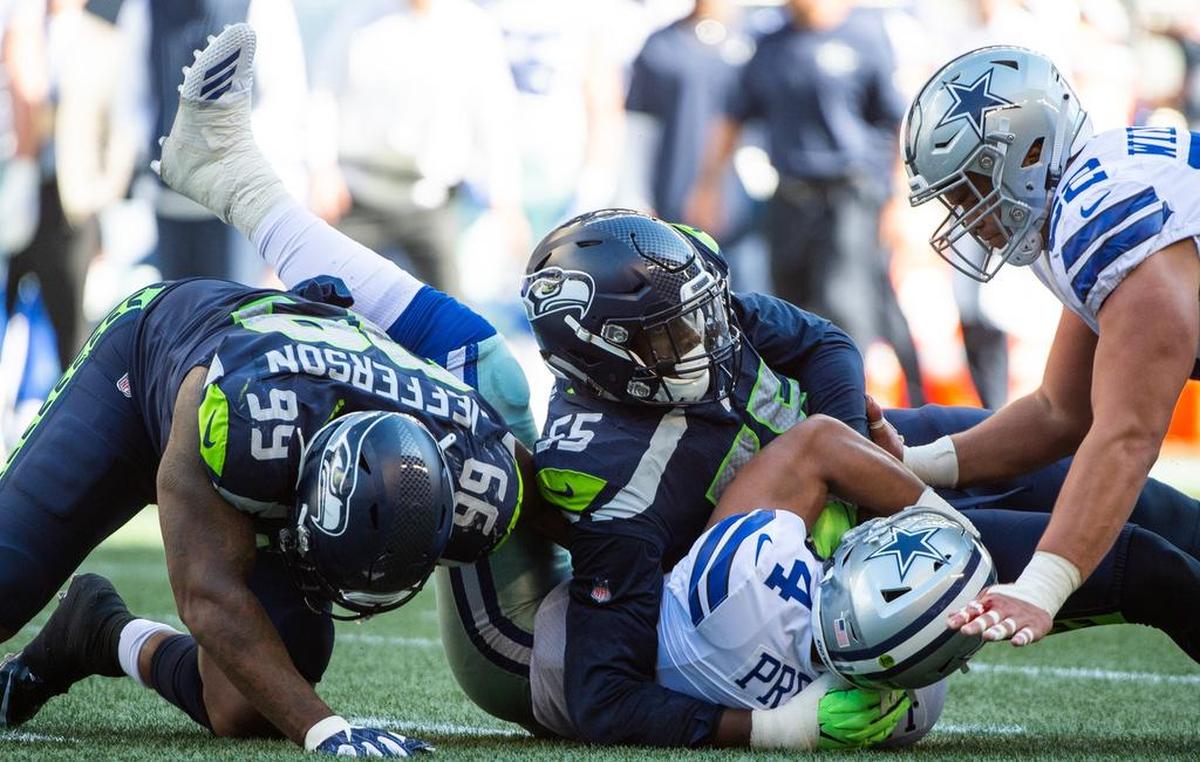 Seahawks defensive ends Frank Clark (55) and Quinton Jefferson (99) sack Cowboys quarterback Dak Prescott in the third quarter of last weekend’s home win over Dallas. Jefferson has been a pleasant surprise in three starts while expected starter Dion Jordan remains injured and iffy, including for Sunday’s NFC West game at Arizona.