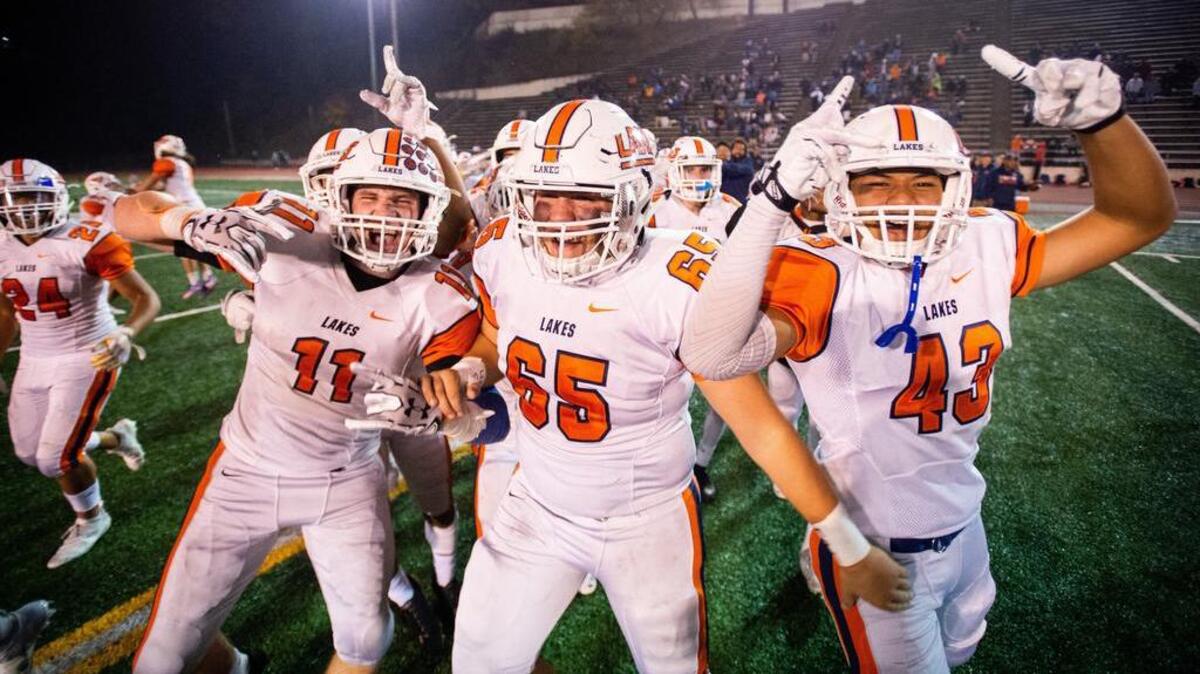 Lakes players including Camyron Gaulke (11), Aaron Evans (65), and Cameron Alefaio (43) celebrate their win against Lincoln. Lincoln high school played Lakes high school in a football game at the Lincoln Bowl in Tacoma, Wash., on Friday, Oct. 19, 2018.