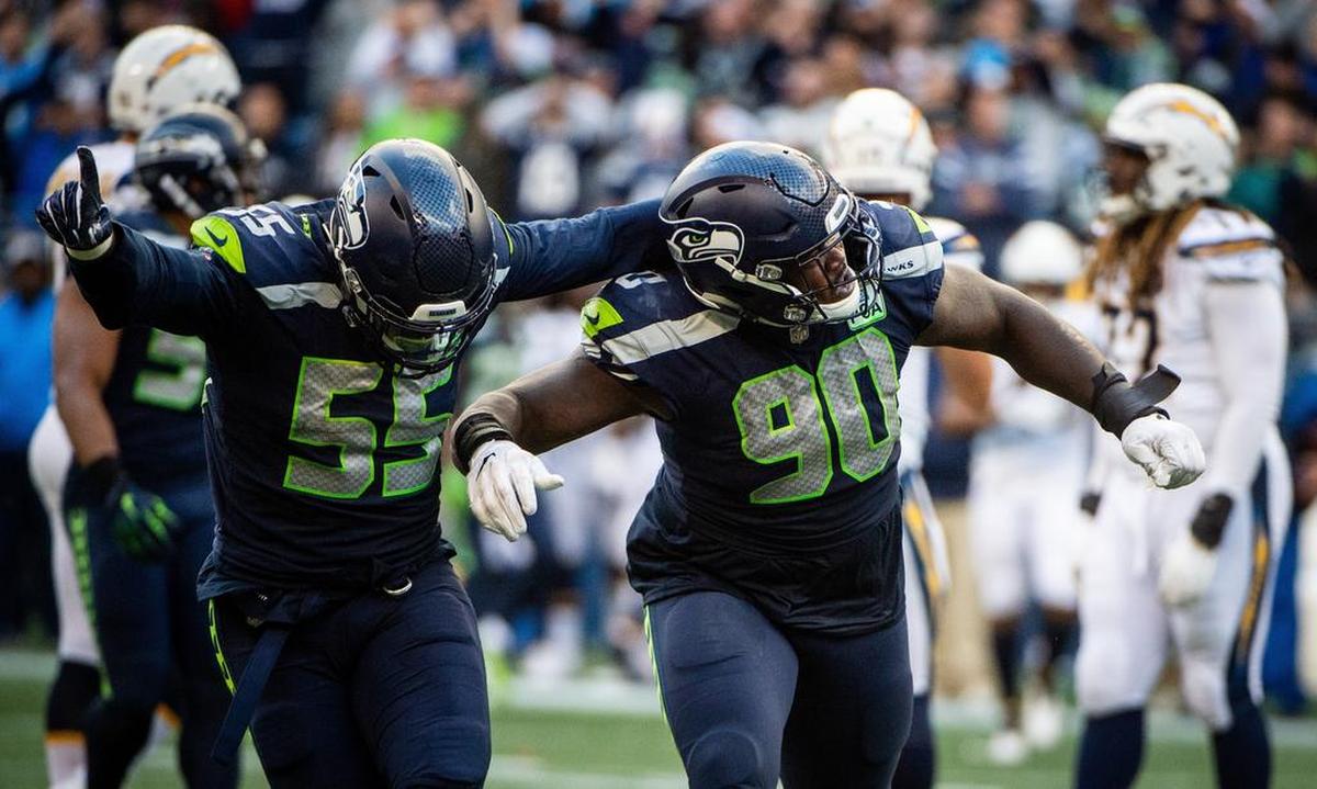 Seahawks defensive lineman Frank Clark and Seahawks defensive lineman Jarran Reed celebrate Reed’s sack of Chargers quarterback Philip Rivers in the fourth quarter. The Seattle Seahawks played the Los Angeles Chargers in a NFL football game at CenturyLink Field in Seattle, Wash., on Sunday, Nov. 4, 2018.