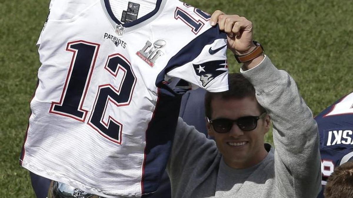 New England Patriots quarterback Tom Brady displays his recovered jersey, which was stolen from the locker room after the Patriots’ February Super Bowl victory over the Atlanta Falcons in Houston, during pregame ceremonies before the Boston Red Sox and the Pittsburgh Pirates opening day baseball game at Fenway Park on Monday in Boston. Dylan Wagner, 19, of Kent led the FBI to the stolen jersey.
